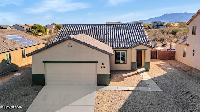 view of front of house with a garage and a mountain view