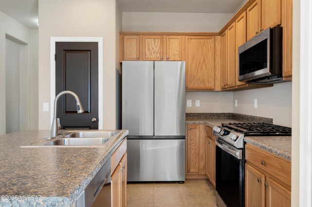 kitchen with stainless steel dishwasher, sink, hanging light fixtures, an island with sink, and light tile patterned floors