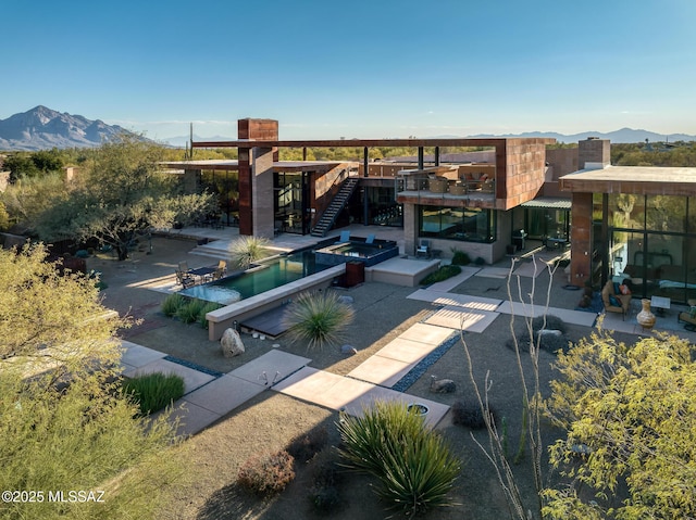 exterior space featuring a mountain view and a patio