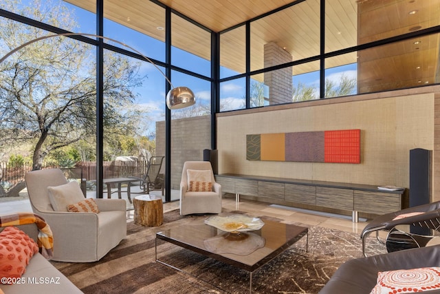 sunroom / solarium with a healthy amount of sunlight and wooden ceiling