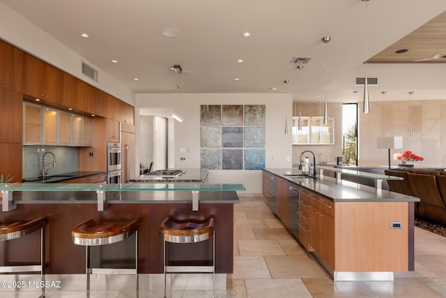 kitchen with pendant lighting, sink, and a kitchen bar