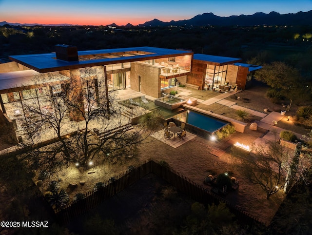 exterior space featuring a mountain view, a jacuzzi, and a patio