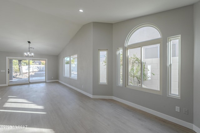 interior space with vaulted ceiling, light hardwood / wood-style flooring, and an inviting chandelier