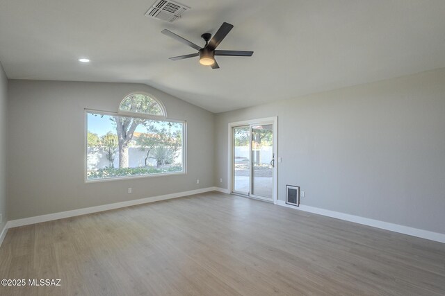 spare room with light hardwood / wood-style floors, ceiling fan, and vaulted ceiling