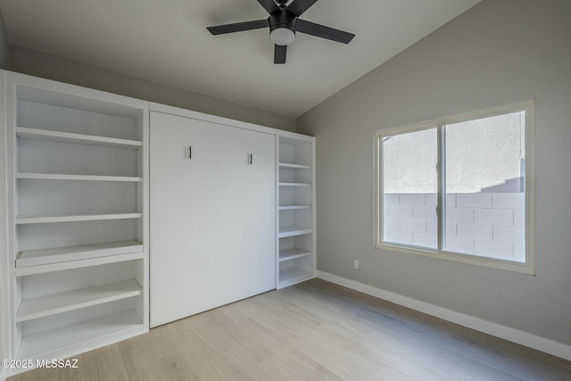 unfurnished bedroom with light wood-type flooring, ceiling fan, and lofted ceiling