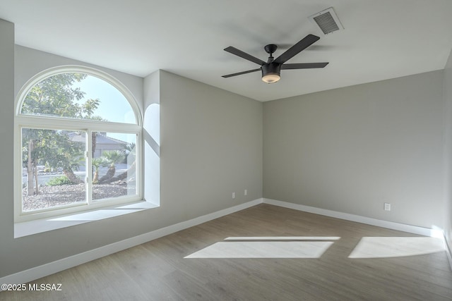 unfurnished room featuring ceiling fan and light wood-type flooring