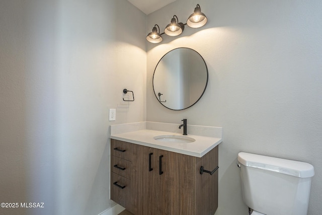 bathroom featuring toilet and vanity