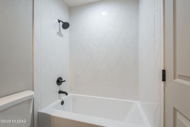 bathroom featuring toilet and tiled shower / bath combo