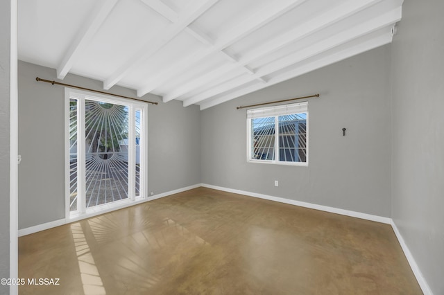 spare room with vaulted ceiling with beams