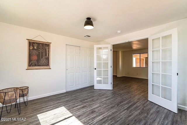 unfurnished room with dark hardwood / wood-style flooring and french doors