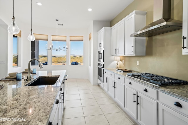 kitchen featuring stainless steel appliances, visible vents, light tile patterned flooring, a sink, and wall chimney exhaust hood