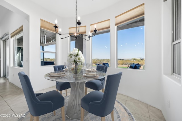 dining space featuring light tile patterned floors and a chandelier