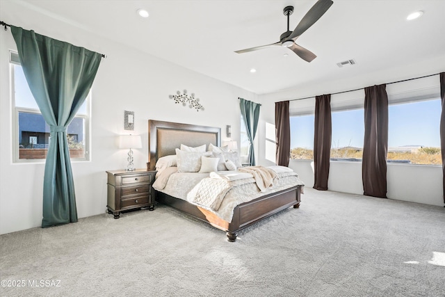 carpeted bedroom with ceiling fan, visible vents, and recessed lighting