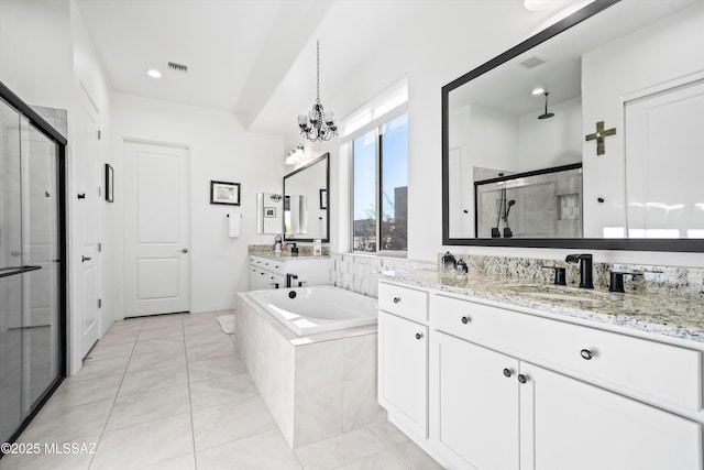 bathroom featuring two vanities, a sink, visible vents, a shower stall, and a bath