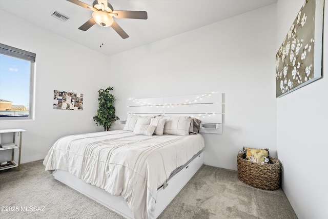 carpeted bedroom with ceiling fan and visible vents