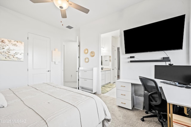 bedroom with ceiling fan, connected bathroom, and light colored carpet