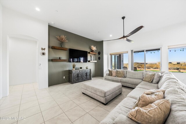 tiled living room featuring ceiling fan