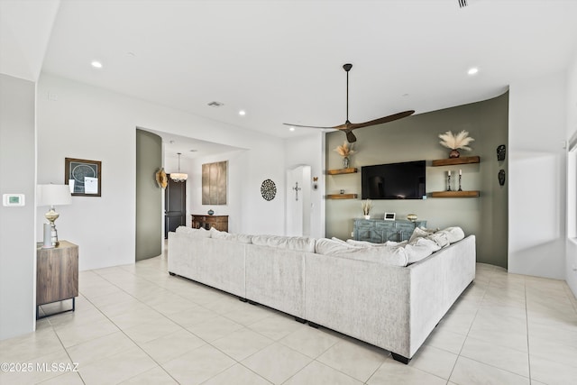 living area with light tile patterned floors, visible vents, a ceiling fan, and recessed lighting