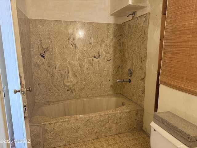 bathroom featuring toilet and bathing tub / shower combination