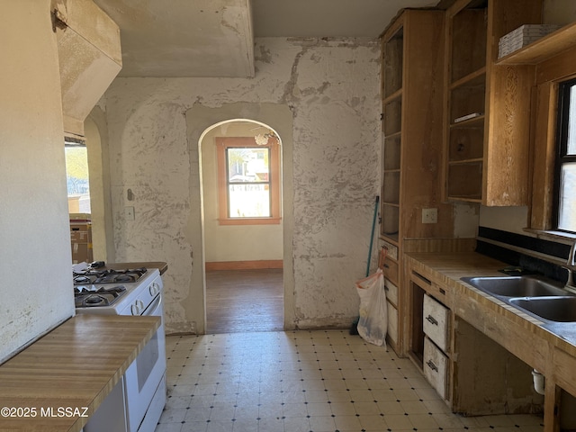 kitchen featuring sink and white gas range oven