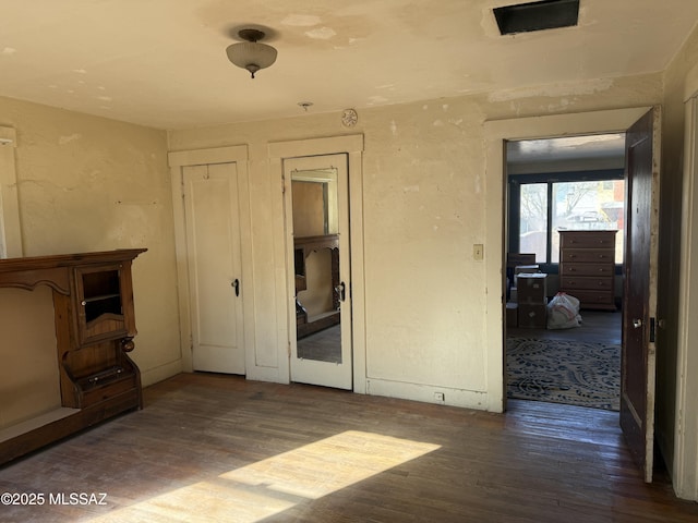 unfurnished bedroom featuring dark hardwood / wood-style flooring