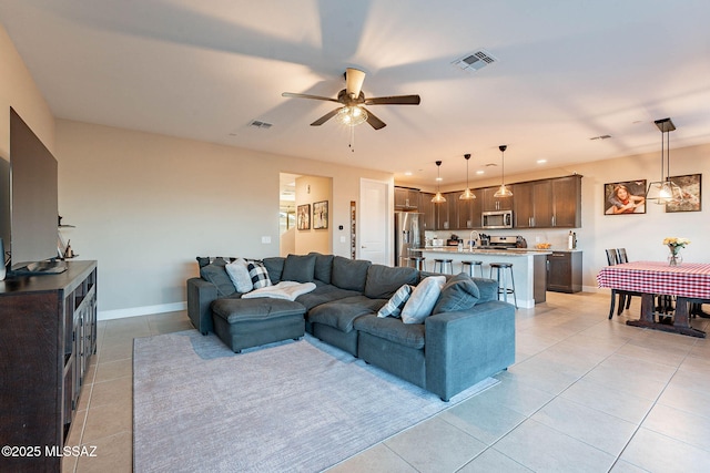 living room with ceiling fan and light tile patterned flooring