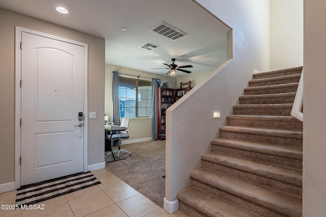 tiled entryway with ceiling fan