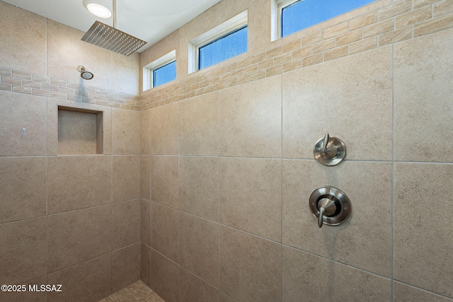 bathroom with a tile shower