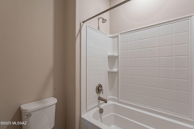 bathroom with tub / shower combination and toilet