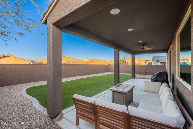 view of patio featuring a mountain view, grilling area, outdoor lounge area, and ceiling fan