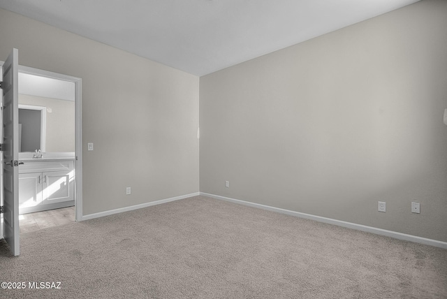 unfurnished bedroom with carpet flooring and baseboards