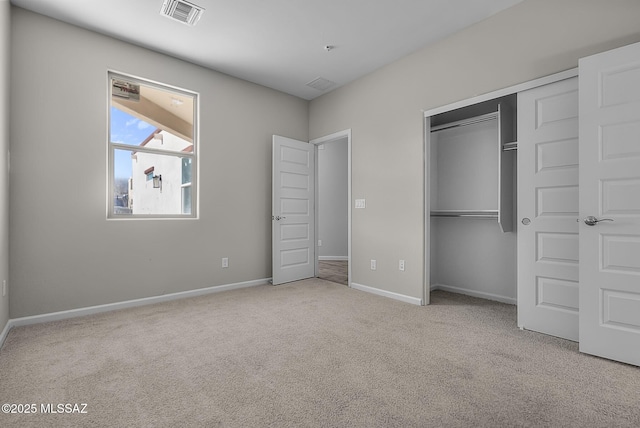 unfurnished bedroom featuring carpet, visible vents, a closet, and baseboards