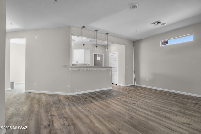 unfurnished living room featuring dark wood-type flooring