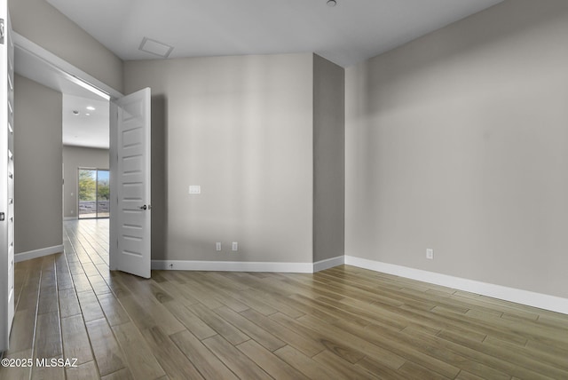 empty room with light hardwood / wood-style flooring