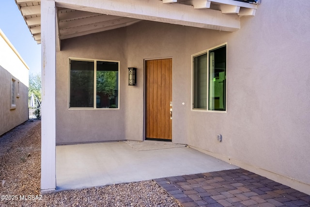 entrance to property featuring a patio area