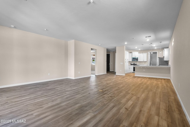 unfurnished living room with light wood-type flooring