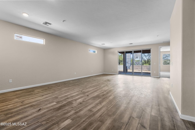 spare room featuring wood-type flooring