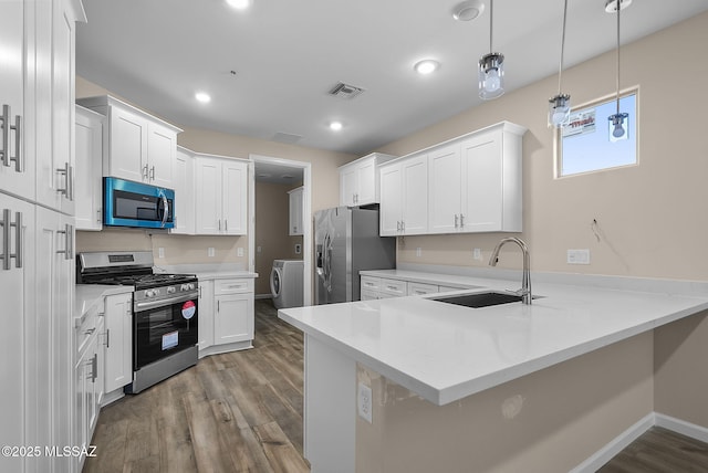 kitchen with pendant lighting, kitchen peninsula, white cabinetry, and stainless steel appliances