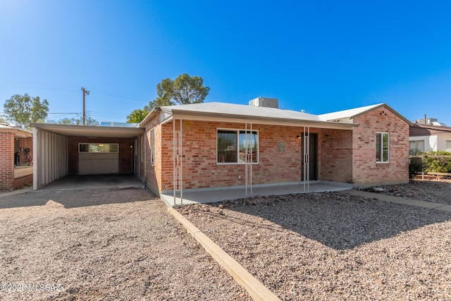 single story home featuring a carport