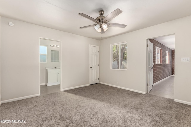 carpeted spare room featuring ceiling fan