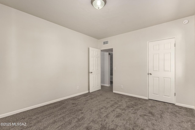 unfurnished bedroom featuring dark colored carpet