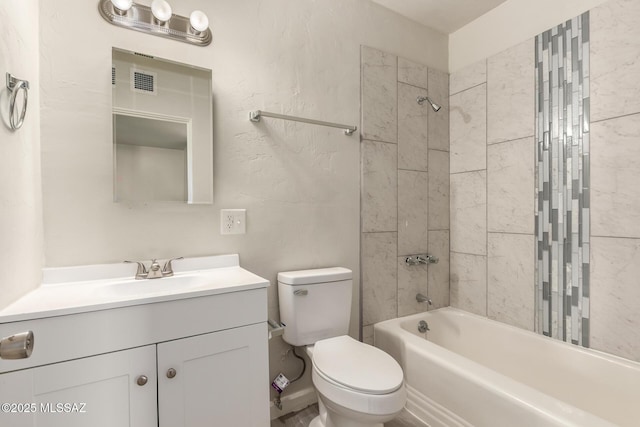 full bathroom featuring toilet, tiled shower / bath combo, and vanity