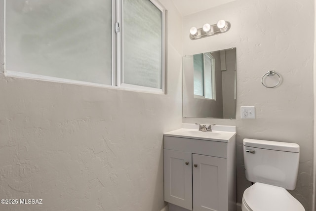 bathroom with toilet and vanity