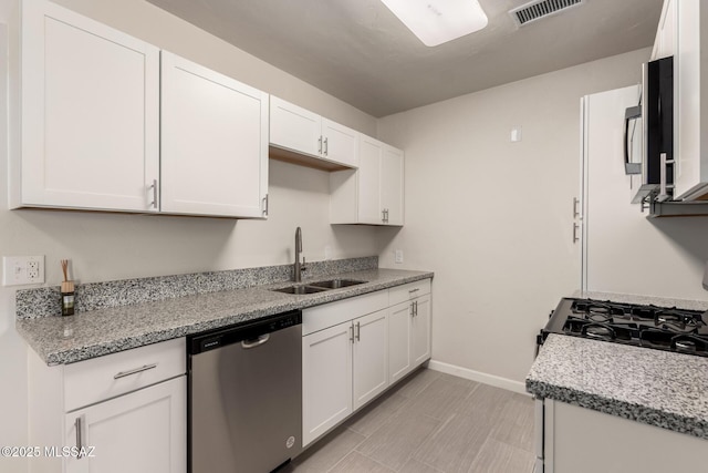 kitchen featuring white cabinetry, sink, light stone counters, and black appliances