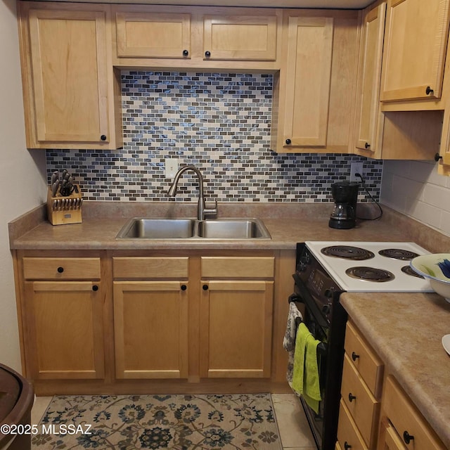 kitchen featuring decorative backsplash, sink, light tile patterned floors, and black range with electric cooktop