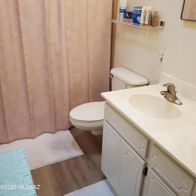 bathroom featuring hardwood / wood-style floors, toilet, and vanity