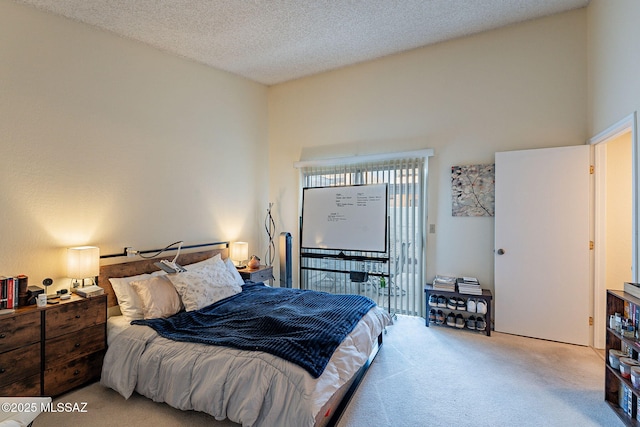 carpeted bedroom with access to outside and a textured ceiling