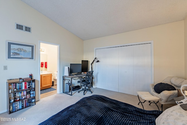 bedroom featuring lofted ceiling, carpet floors, a closet, and visible vents