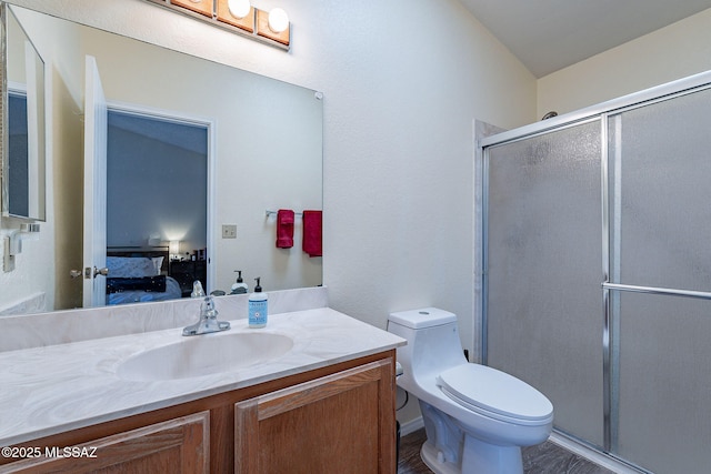 full bath with toilet, a shower stall, ensuite bath, and vanity