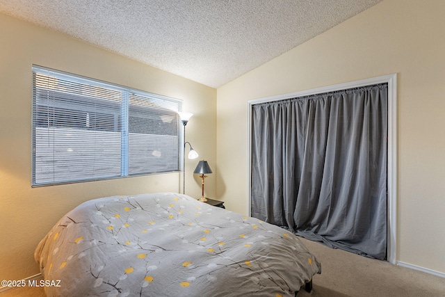 carpeted bedroom featuring vaulted ceiling and a textured ceiling